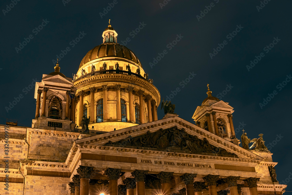 view of the majestic facade of St. Isaac's Cathedral against the dark night sky