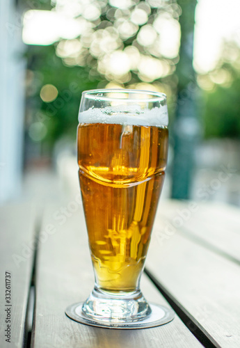 A glass of beer on a table.Nice soft background.