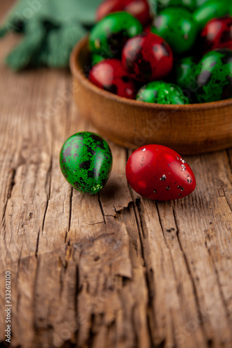 Easter eggs background. Green and red eggs. Colorful Quail colored eggs. Place for text. Different little painted egg set. Dietary nutrition. 
