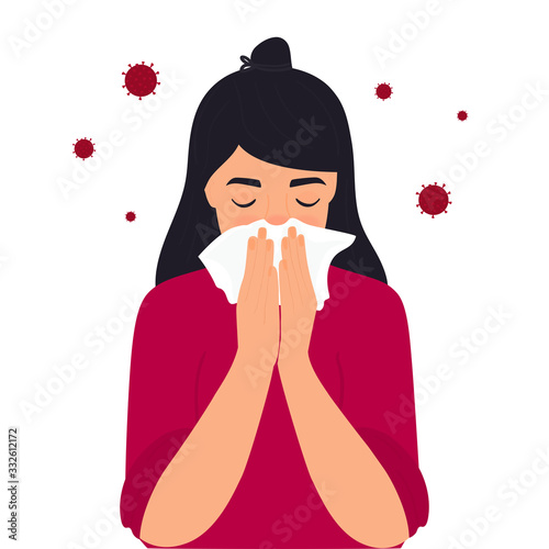 COVID-19. Coronavirus symptoms. The girl is coughing behind a napkin. Runny nose