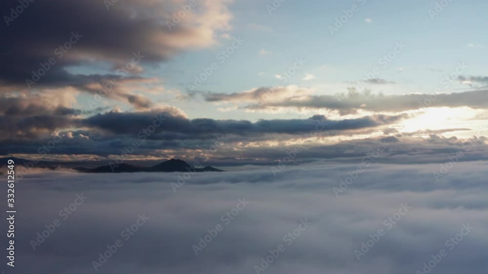 AERIAL Sun Shining Through Clouds With White Cumulus Below AERIAL Sun Shining Through Clouds With White Cumulus Below