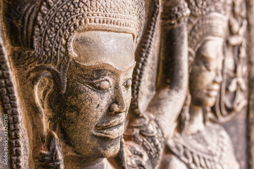 Ancient Khmer carving/relief of goddess detail. Wall of Temple Angkor wat, Siem Reap, Cambodia.