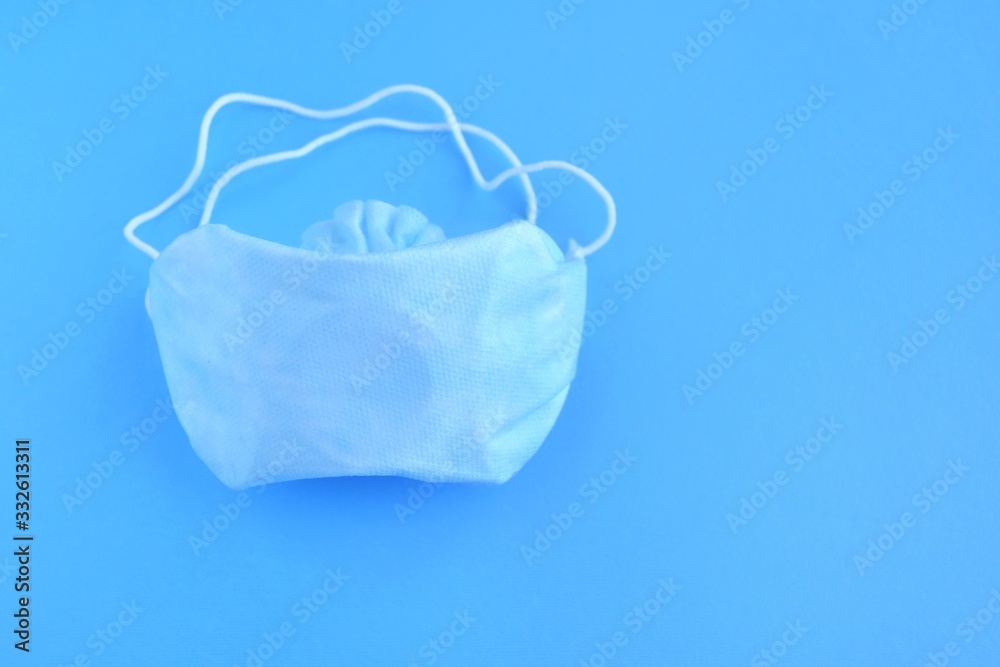Sterile protection face mask against coronavirus ffp2. Increased potential. high demand. face mask against covid-19, virus, flu coronavirus. breathing medical mask on blue background Sterile protection face mask against coronavirus ffp2. Increased potential. high demand. face mask against covid-19, virus, flu coronavirus. breathing medical mask on blue background