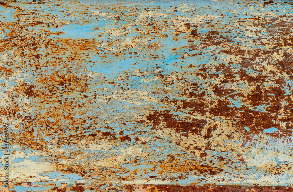 rust and damaged blue and yellow paint on metal sheet
