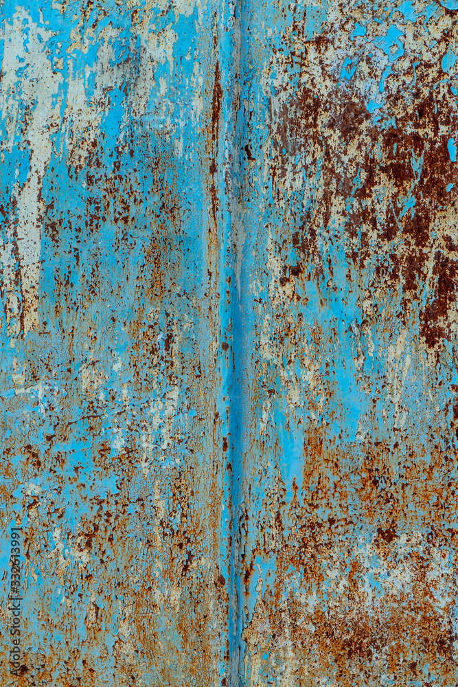 rust and damaged blue and yellow paint on metal sheet