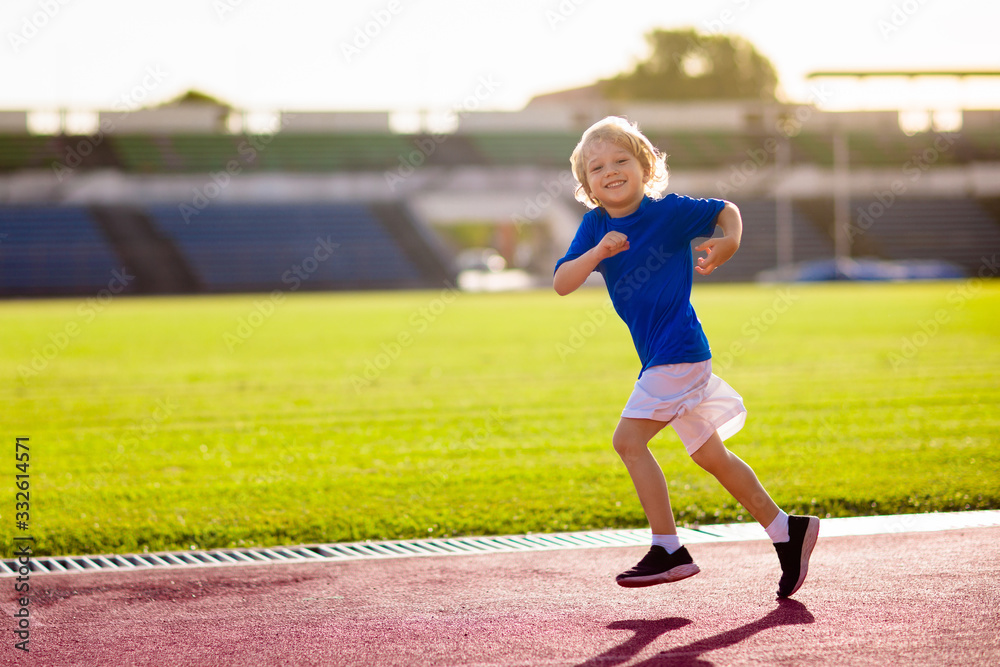 Fototapeta premium Child running in stadium. Kids run. Healthy sport.