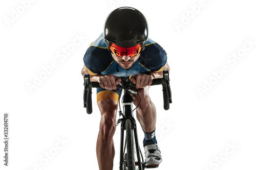 Triathlon male athlete cycle training isolated on white studio background. Caucasian fit triathlete practicing in cycling wearing sports equipment. Concept of healthy lifestyle, sport, action, motion.