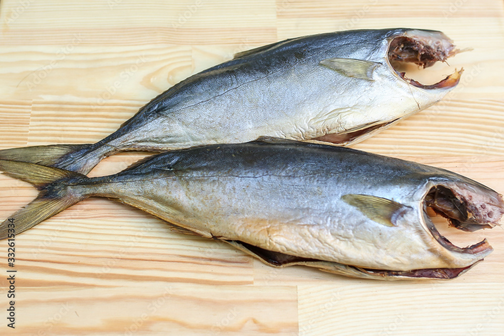 salted, smoked and dried fish, beer snacks, tasty fish on a wooden board salted, smoked and dried fish, beer snacks, tasty fish on a wooden board