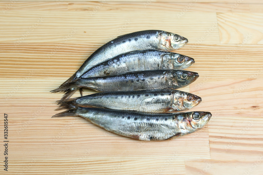 salted, smoked and dried fish, beer snacks, tasty fish on a wooden board salted, smoked and dried fish, beer snacks, tasty fish on a wooden board