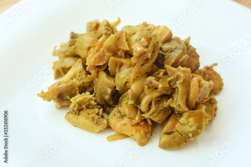  salad of seafood, mussels, raps, squids, on a white plate on a wooden background