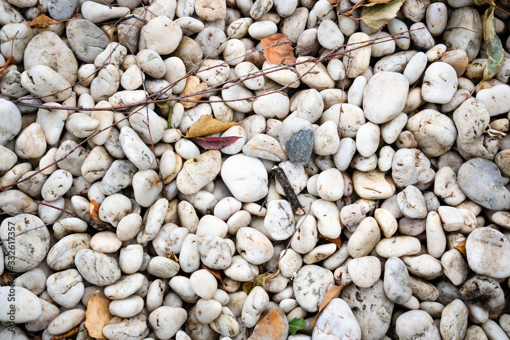 White smooth sea stones set in the yard. Marine decor in the garden. White smooth sea stones set in the yard. Marine decor in the garden.