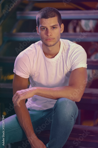 Close-up portrait of attractive male model. Young handsome man in a bar