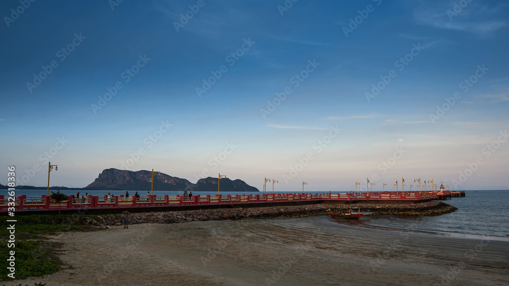 The red bridge and the people who exercise Walk to see the view at Prachuap Bay in the evening time in Thailand.