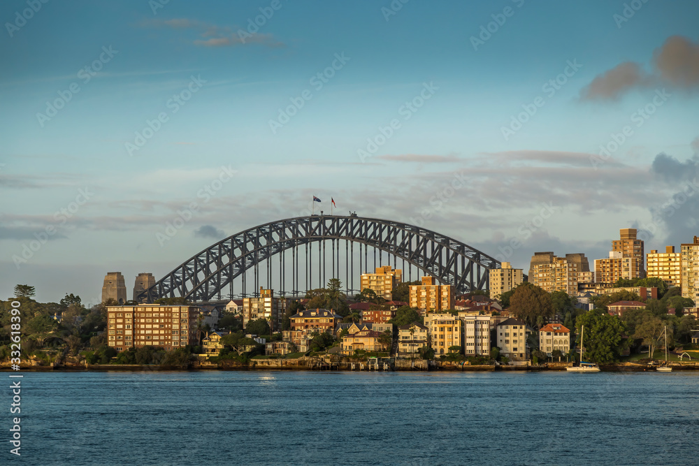 The Harbour Bridge in Sydney, New South Wales in Australia during a cloudy but warm day in summer. The Harbour Bridge in Sydney, New South Wales in Australia during a cloudy but warm day in summer.
