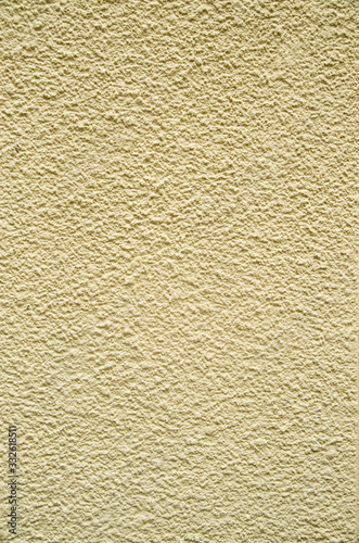Yellow painted plaster on wall