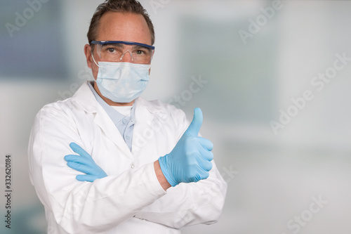 doctor with medical face mask and medical gloves shows thumbs up