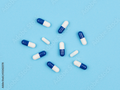 Medicinal capsules on a blue background.