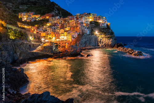Panoramic night view of beautiful town of Manarola - one of five famous colorful villages of Cinque Terre National Park in Italy, Liguria region.