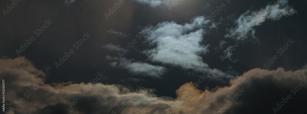 Dramatic, textured сlouds in sky over the Moscow. Natural background. A shot of the sun in the sky. Filter is applied, so sun looks like the moon at night. Concept of threat of biological infection Dramatic, textured сlouds in sky over the Moscow. Natural background. A shot of the sun in the sky. Filter is applied, so sun looks like the moon at night. Concept of threat of biological infection