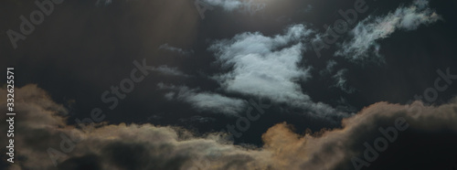 Dramatic, textured сlouds in sky over the Moscow. Natural background. A shot of the sun in the sky. Filter is applied, so sun looks like the moon at night. Concept of threat of biological infection © Yury and Tanya