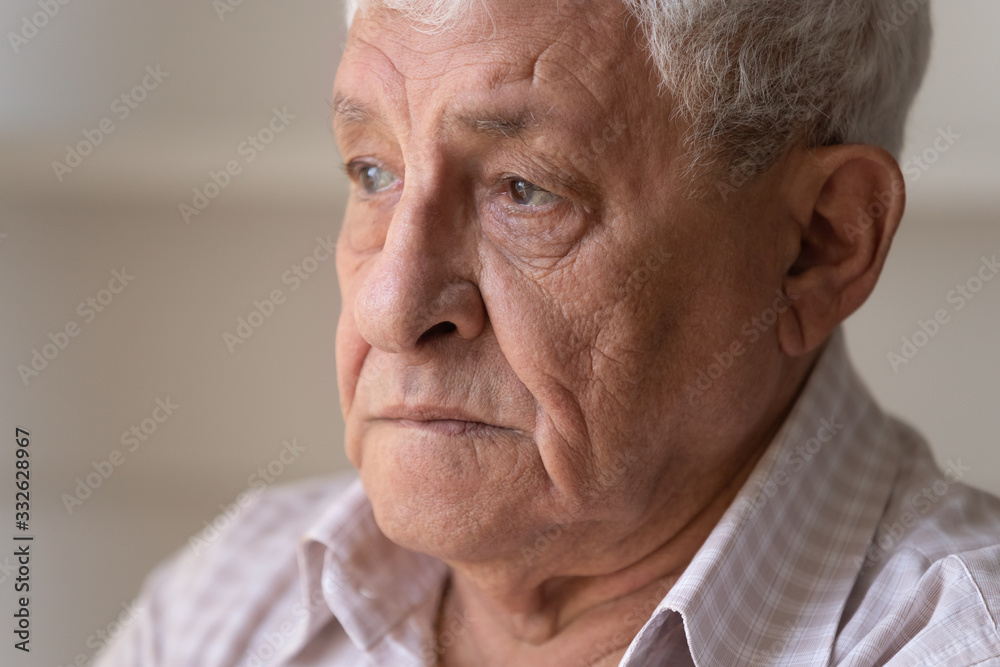 Head shot close up unhappy lonely thoughtful older man looking to away in distance, upset mature grandfather lost in thoughts or memories, thinking about problem, elderly and nostalgia and loneliness Head shot close up unhappy lonely thoughtful older man looking to away in distance, upset mature grandfather lost in thoughts or memories, thinking about problem, elderly and nostalgia and loneliness