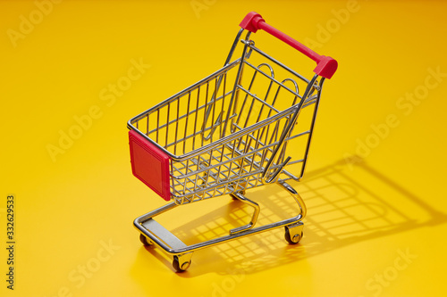 Empty Shopping Cart Against Yellow Background