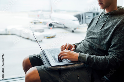 Man sitting with laptop at the airport