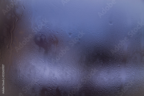 Wet glass background. Raindrops on the glass. The misted window.