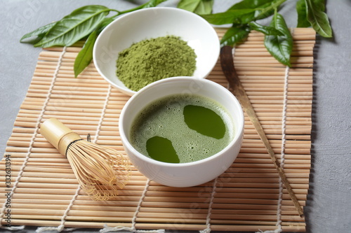 Green matcha tea drink and tea accessories on white background. Japanese tea ceremony concept. Detox tea. Antioxsidant drink