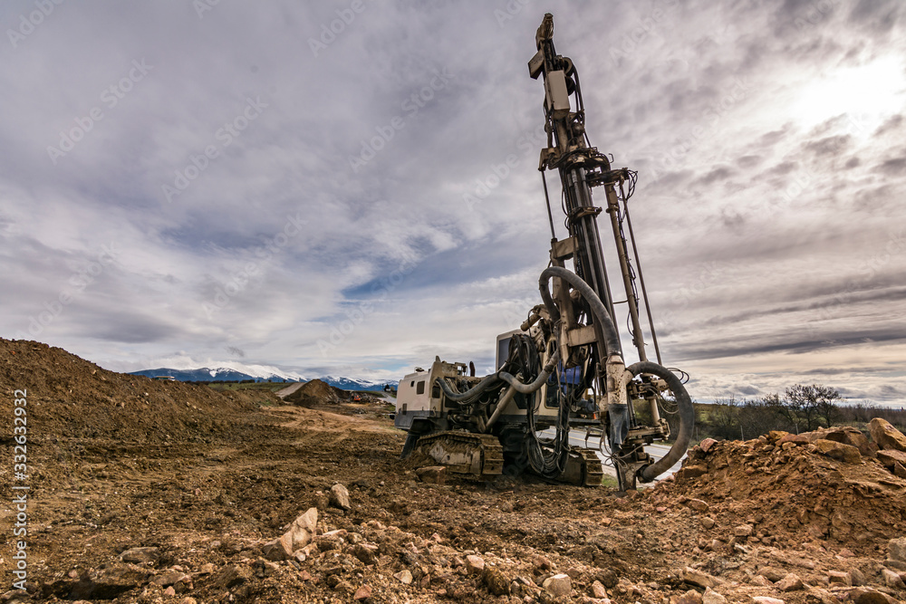 Drilling rock in the works of creating a road Drilling rock in the works of creating a road