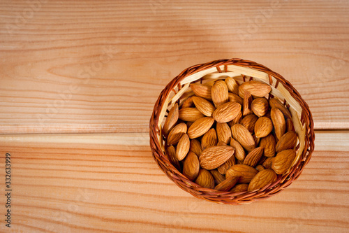 Almonds nuts shot large on a wooden background. Background for healthy eating and vegetarianism.