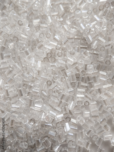 macro closeup on transparent white glass tube beads for couture bridal wear