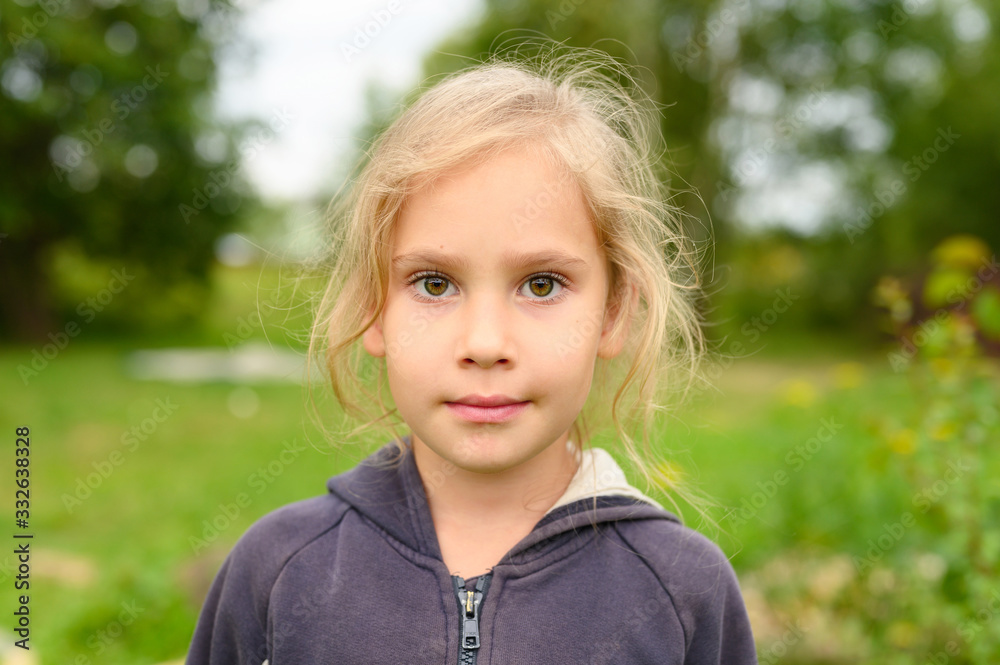 portrait of a cute little six year old european girl on the background of nature outdoor portrait of a cute little six year old european girl on the background of nature outdoor