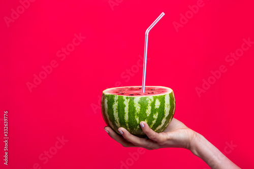 Watermelon juice in woman hand concept. Creative art minimal food photo