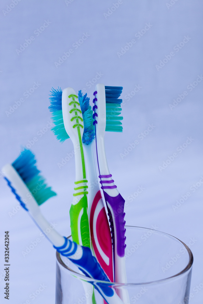 Several toothbrushes of different colors in a base and white background Several toothbrushes of different colors in a base and white background
