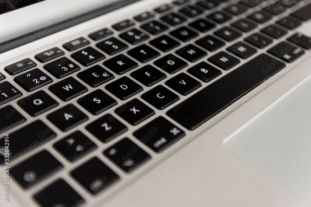 laptop's keyboard view from the left oblique front side · left center part of the focused keyboard laptop's keyboard view from the left oblique front side · left center part of the focused keyboard