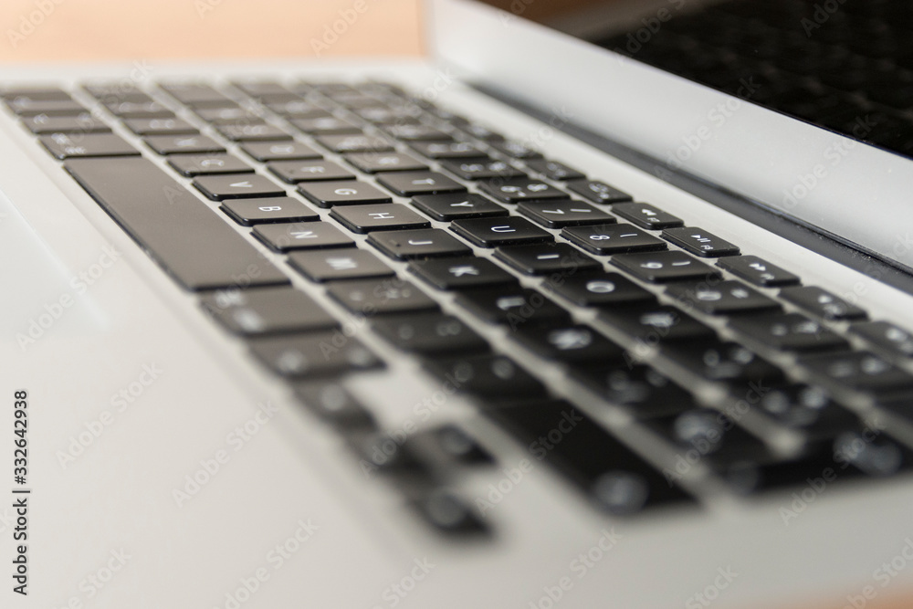 gray laptop keyboard seen from the right side gray laptop keyboard seen from the right side