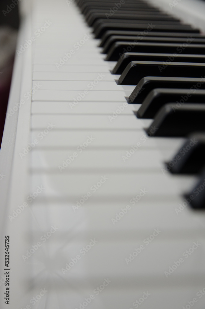 close-up of piano keys. close frontal view, black and white piano keys, viewed from side close-up of piano keys. close frontal view, black and white piano keys, viewed from side