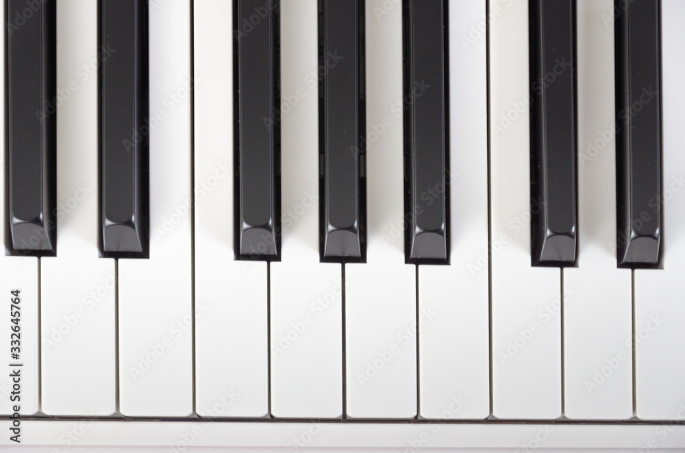 close-up of piano keys. close frontal view, black and white piano keys, viewed from above, top view close-up of piano keys. close frontal view, black and white piano keys, viewed from above, top view