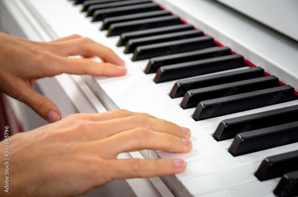 Obraz premium close-up of piano keys. close frontal view, black and white piano keys, viewed from side, musician hands playing piano, concept for live music festival. classical music, Instrument on stage