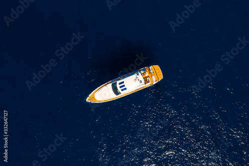 Aerial drone top down photo of Luxury Yacht boat near the famous island of Capri, Italy.