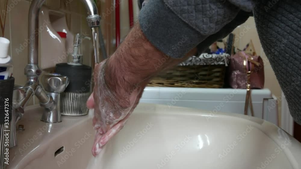 Man in quarantine washing his hands in a sink. Covid-19 pandemic precautions. Static shot. Man in quarantine washing his hands in a sink. Covid-19 pandemic precautions. Static shot.