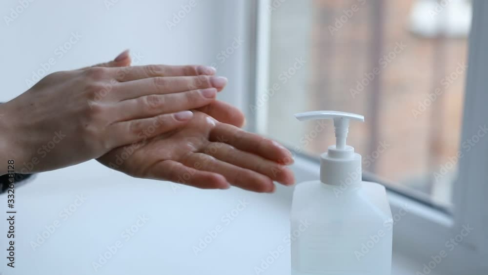 Close-up of woman hands using hand sanitizer gel to prevent spreading virus (such as corona virus / covid-19 / sars-cov-2) or bacteria. real time footage. Close-up of woman hands using hand sanitizer gel to prevent spreading virus (such as corona virus / covid-19 / sars-cov-2) or bacteria. real time footage.