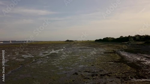 Flying over low tide river and harbour