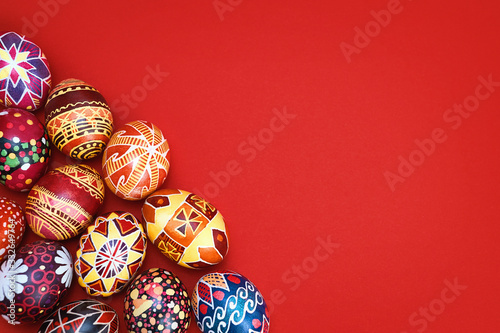 colored, floral easter eggs on a red background, place for text. Easter holiday.