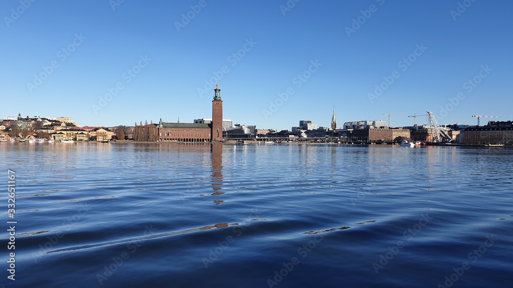 Fototapeta premium Panoramic view of the sea bay and the city against the blue sky. Spring Sweden