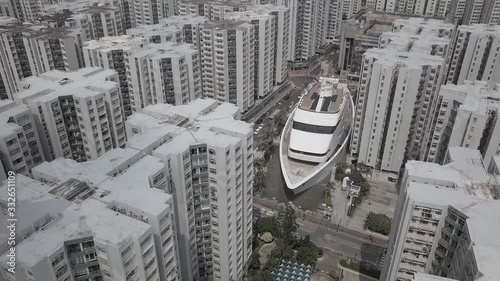 Tilting aerial shot of Whampoa Gardens in Hong Kong.  The shopping centre is a cruise ship in the middle of the city.