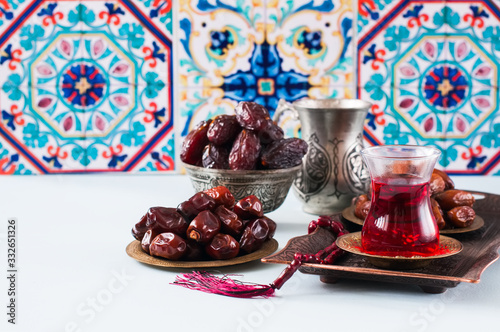 Assorted dried dates or kurma in a vintage plates and tea