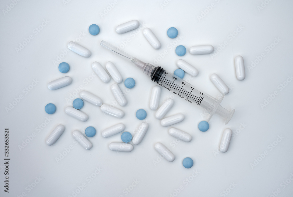 pills and syringe isolated on white background pills and syringe isolated on white background