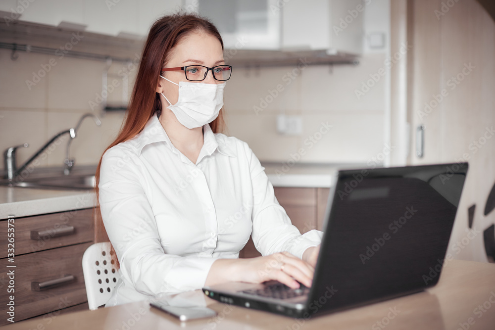 remote work at home during quarantine and epidemic, portrait of a woman in a medical mask